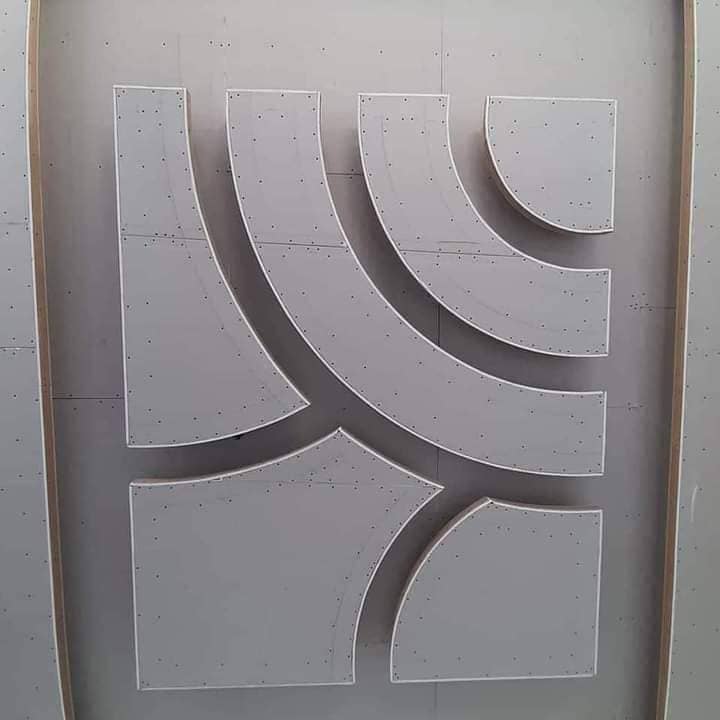 Custom curved gypsum board wall installation showing advanced bending and forming techniques