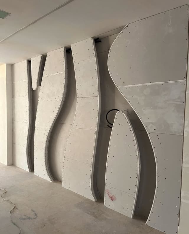 Specialized moisture-resistant gypsum board installation in bathroom with proper vapor barriers