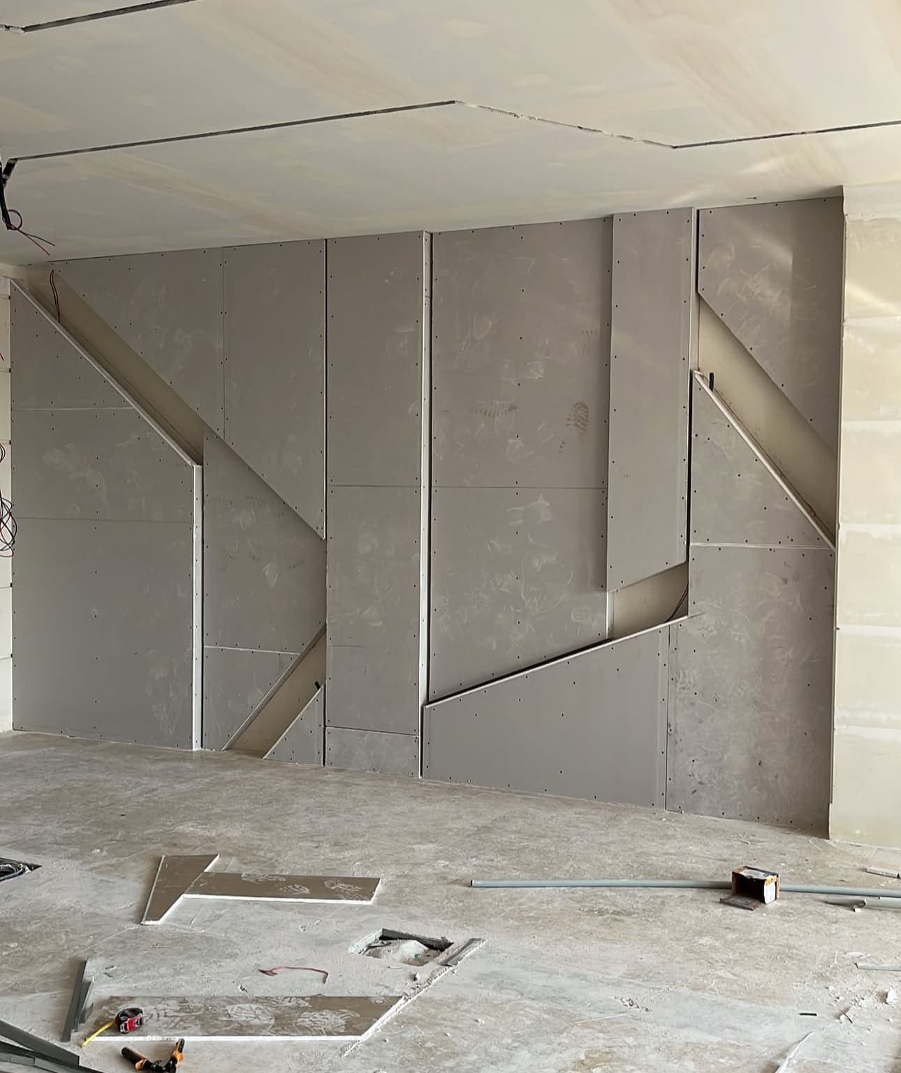 Gypsum board installation on exterior wall with proper moisture barriers and insulation