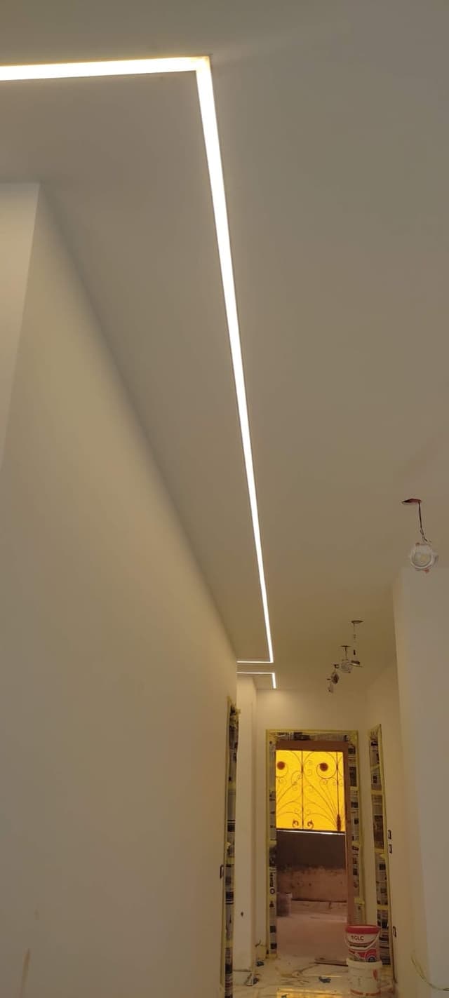 Complete room gypsum board installation with walls and ceiling work in residential setting