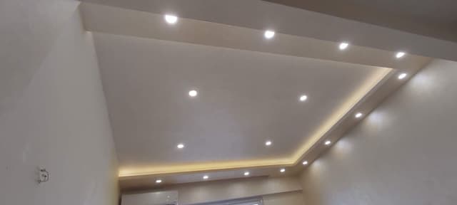 Finished basement gypsum board installation with proper moisture control and insulation