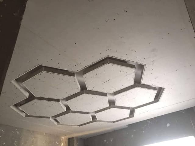 Gypsum board installation with decorative elements and specialized finishing techniques