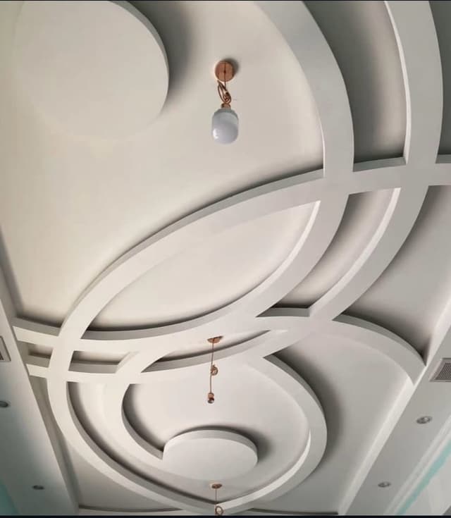 Gypsum board work around exposed beams with precise cutting and rustic finishing techniques