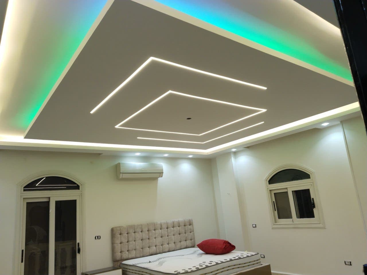 Complex stairwell gypsum board installation with angled cuts and precise measurements