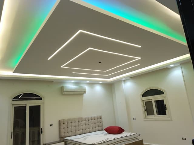 Complex stairwell gypsum board installation with angled cuts and precise measurements